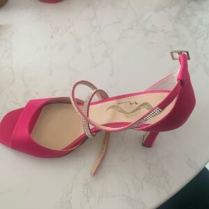 Pink stilettos satin rhinestone studded shoes.